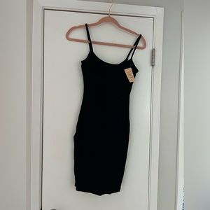 Black little dress. Brand new. With body shaping built in. Flattering.